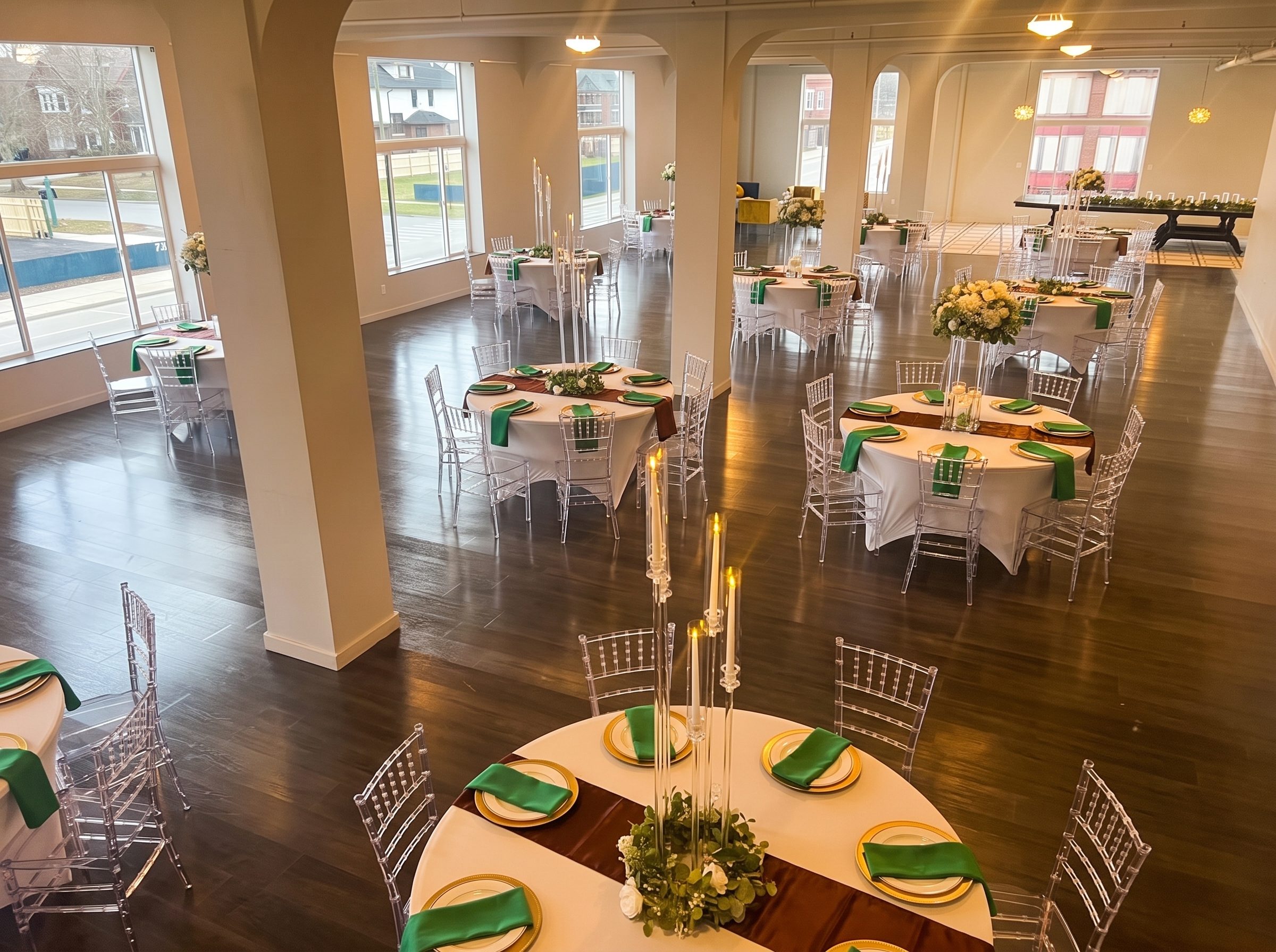 The Kercheval Gallery set with round tables, gold chargers, and candle centerpieces